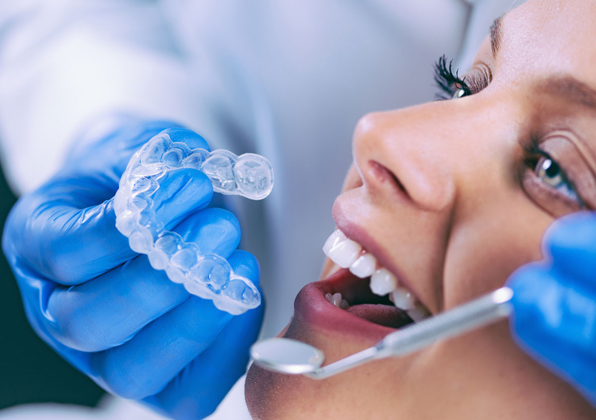 A dentist holding invisalign braces
