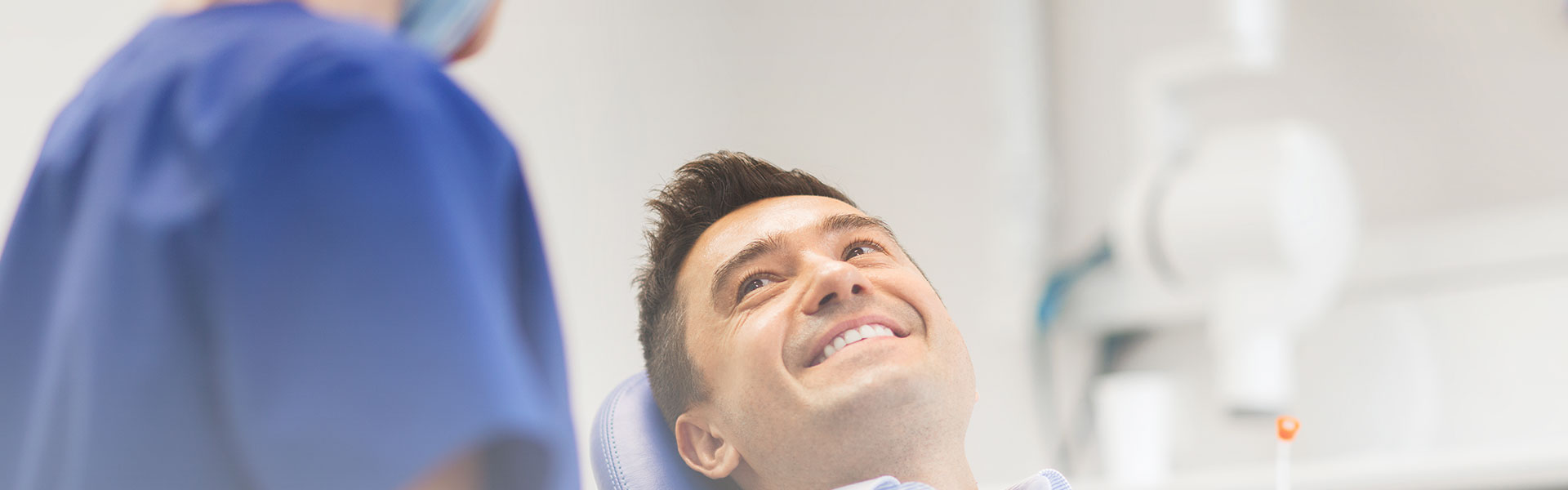 A man is smiling after dental bridges