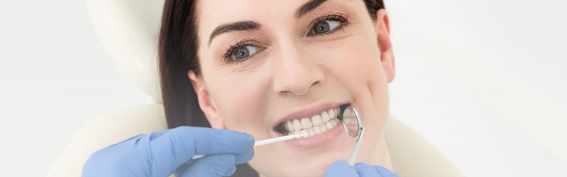 A woman is having dental cleanings treatment